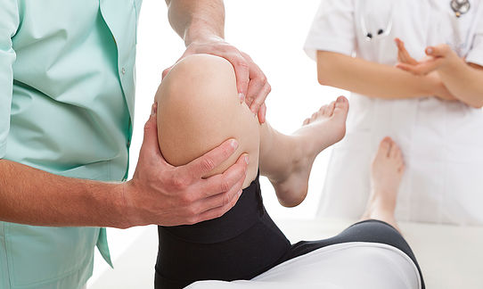 chiropractor adjusting knee